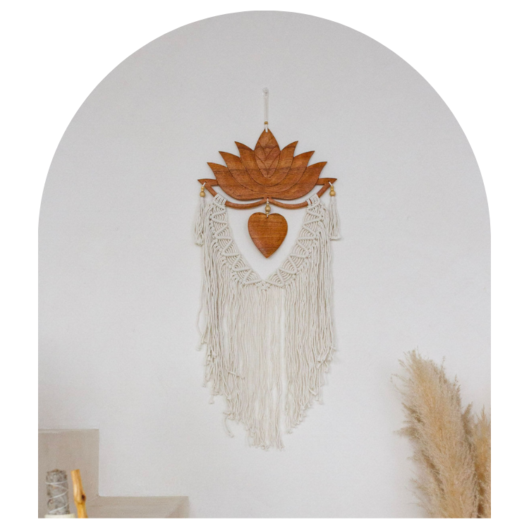Decorative wall hanging with lotus design and fringes on a plain background