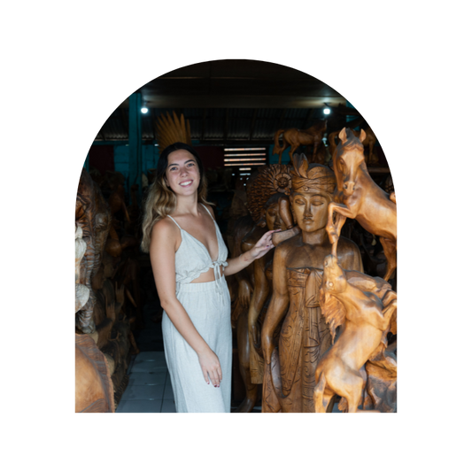 Girl by wooden full sized Buddha status