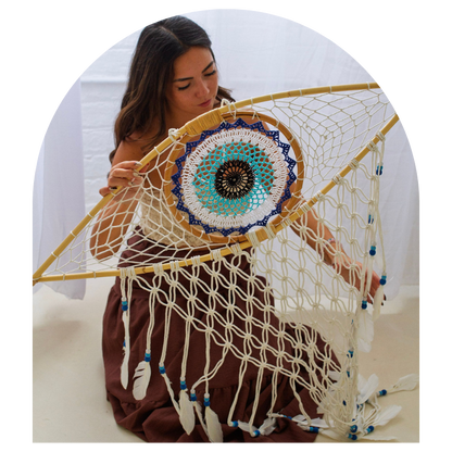 Woman holding a large dreamcatcher with intricate patterns