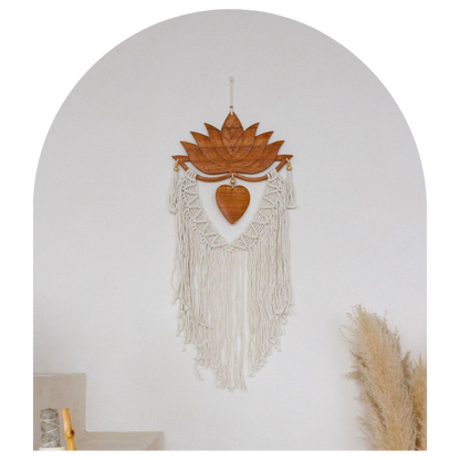 Decorative wall hanging with lotus design and fringes on a plain background