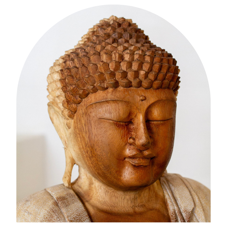 Wooden Buddha statue head on a white background