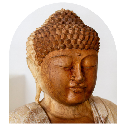Wooden Buddha statue head on a white background